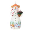 Hallmark Snowtop Lodge Terran S. Gardner Porcelain Ornament -Ornament Shop Snowman with Flower Pot Keepsake Ornament 2299QXR8119 01